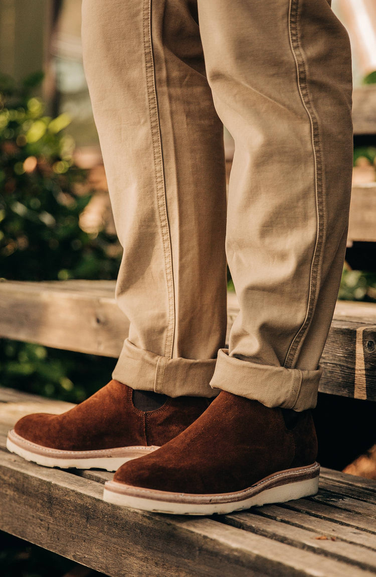 our model wearing the boots near a cabin with text overlaying