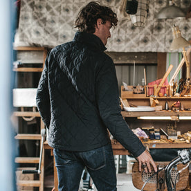 The fit model wearing the vertical jacket in his art shop