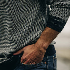 fit model with sleeve pulled up wearing The Brume Sweater in Navy Birdseye