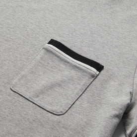 material shot of chest pocket of The Heavy Bag Ringer Tee in Aluminum