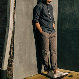 fit model leaning against a wall in The Jack in Dark Navy Oxford