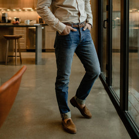 fit model with hand in pockets posting in kitchen wearing The Slim Jean in Sawyer Wash Organic Selvage