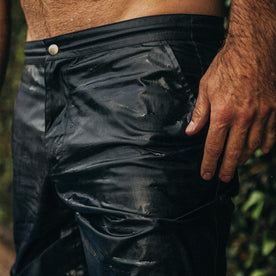 fit model wearing The Adventure Short in Navy from Taylor Stitch, drying after jumping in the pool