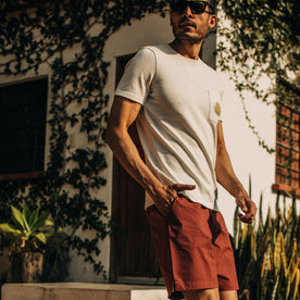 fit model wearing The Adventure Short in Rust, hand in pocket