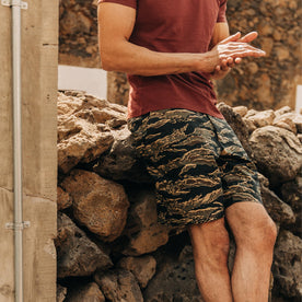 fit model wearing The Adventure Short in Tiger Camo, hands clasped