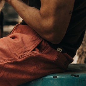 fit model wearing The Apres Short in Rust Hemp, side pocket shot