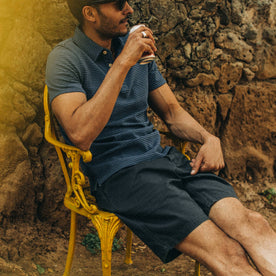 fit model wearing The Camp Short in Navy Herringbone, sitting