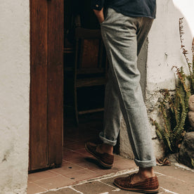 fit model wearing The Easy Pant in Navy Herringbone, cuffed with shoes, walking indoors