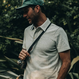 fit model wearing The Heavy Bag Polo in Natural and Ash Stripe, holding camera