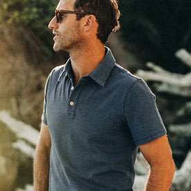 fit model wearing The Heavy Bag Polo in Navy Stripe, looking left of camera