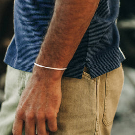 fit model wearing The Heavy Bag Polo in Navy Stripe, side detail