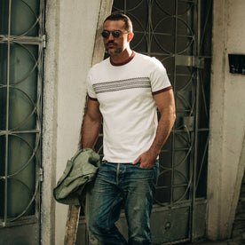 fit model wearing The Heavy Bag Tee in Canyon Embroidered Stripe, holding jacket