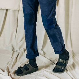 material shot of The Atelier and Repairs Chino in Navy, model standing diagonal
