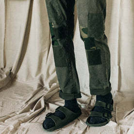 material shot of The Atelier and Repairs Chino in Olive, model standing diagonal