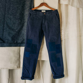 material shot of The Atelier and Repairs Chino in Navy, cuffed on hanger