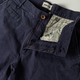 material shot of The Atelier and Repairs Chino in Navy, fly shot