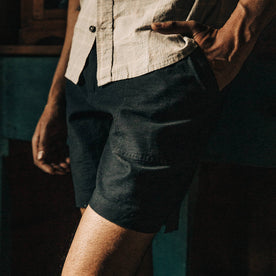 fit model wearing The Trail Short in Navy Reverse Sateen, cropped up close, left hand in pocket