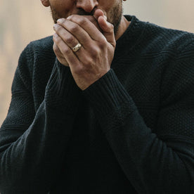 fit model warming his hands while wearing The Ventana Sweater in Navy