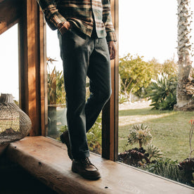 fit model wearing The Camp Pant in Coal Boss Duck, walking indoors