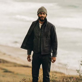 fit model wearing The Decker Jacket in Navy Wool Beach Cloth, standing near coast