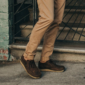 fit model wearing Foundation Pant, cuffed with boots