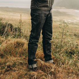 fit model wearing The Democratic Jean in Nihon Menpu Selvage, standing on grass