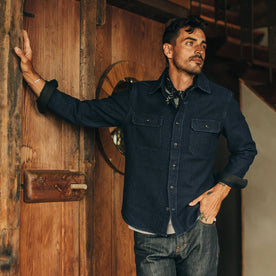 fit model wearing The Division Shirt in Indigo Twill from Taylor Stitch, looking right