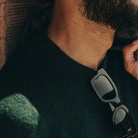 fit model wearing The Double Knit Sweater in Forest, shot of sunglasses on collar