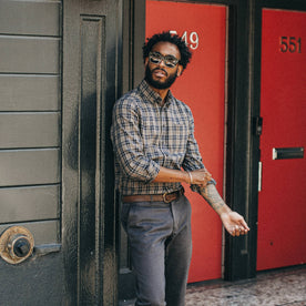 fit model wearing The Jack in Sand Plaid, sunglasses on, cuffing sleeves