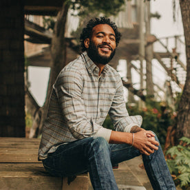 fit model wearing The Jack in Sky Plaid, smiling, sitting on deck