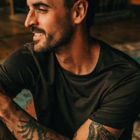 fit model wearing The Merino Tee in Heather Espresso, looking left, up close