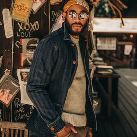 fit model wearing The Ojai Jacket in Washed Indigo Herringbone, sunglasses on, looking into camera