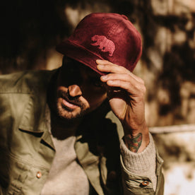 fit model holding The Ball Cap in Burgundy Cord