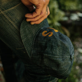 fit model holding The Ball Cap in Organic Denim