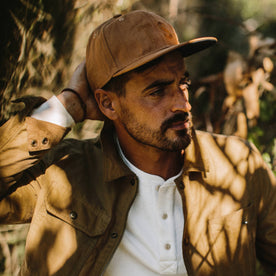 fit model holding The Ball Cap in Tobacco Boss Duck