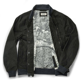 flatlay of The Bomber Jacket in Waxed Olive open from the front