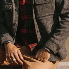 fit model wearing The Explorer Shirt in Coal Herringbone Wool showing cuffs and front chest pockets