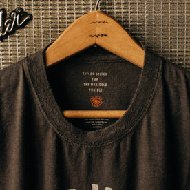 material shot of The Cotton Hemp Tee in Flower Power hanging up on a speaker