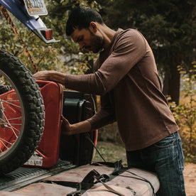 fit model wearing the heavy bag, putting gas can in truck