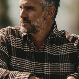 fit model wearing The Ledge Shirt in Espresso Plaid, looking left