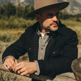 fit model wearing The Maritime Shirt in Navy Wool while leaning against a railing