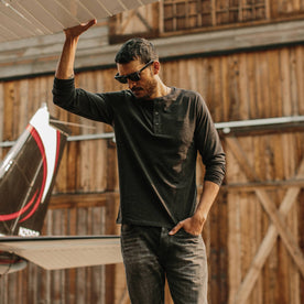 fit model wearing The Merino Henley, looking down