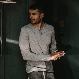 fit model wearing The Merino Henley, looking left