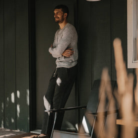 fit model wearing The Merino Henley, leaning against doorframe