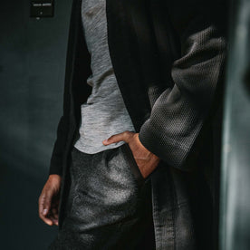 fit model wearing the robe showing the sleeve with his hand in his pocket