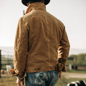 fit model wearing The Lined Long Haul Jacket in Sand Suede showing the back with cuffed sleeves