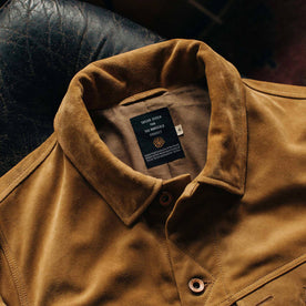 material shot showing collaboration tag on The Lined Long Haul Jacket in Sand Suede