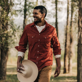 fit model wearing our shirt in the forest