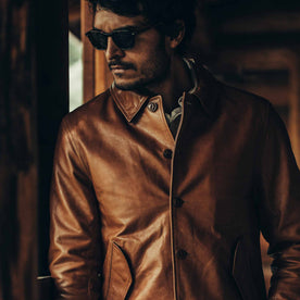 fit model wearing The Cuyama Jacket in Cognac, looking left, sunglasses on