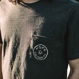 our fit model wearing The Hope + Solidarity Heavy Bag Tee in Heather Grey